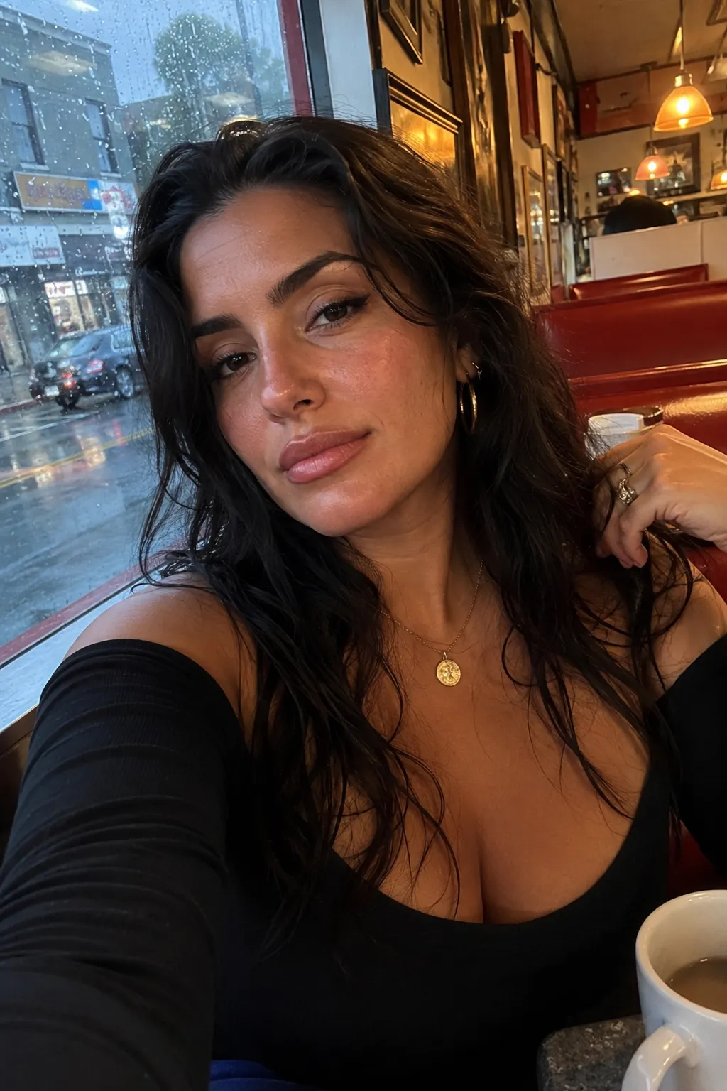 Rainy-diner selfie in a red booth.
